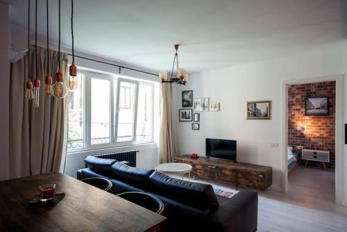 a living room with a couch and a table at Retro MidTown Apartment in Bucharest