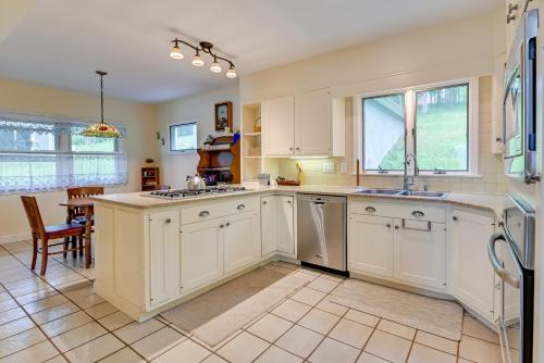 a large kitchen with white cabinets and a sink at Lakefront Canandaigua Home with Dock and Kayak! in Canandaigua