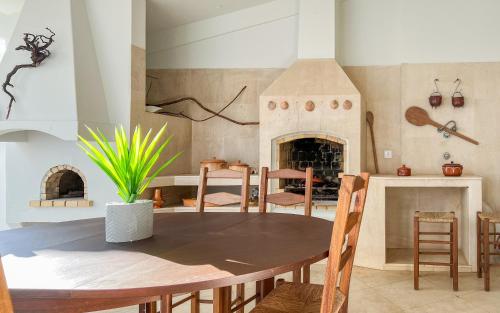 a dining room with a table and a fireplace at Loulé Sunny Retreat by LovelyStay in Loulé