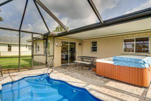 a house with a swimming pool and a hot tub at Canalfront Retreat with Heated Pool and Hot Tub! in Port Charlotte