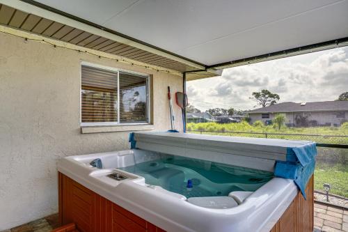 a large bath tub with blue water in it at Canalfront Retreat with Heated Pool and Hot Tub! in Port Charlotte