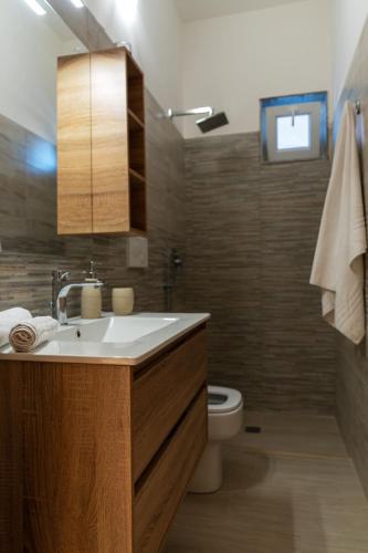 a bathroom with a sink and a toilet at Casa Vacanze da Nino in Torre Lapillo