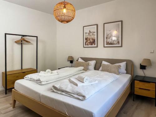 a bedroom with two beds and a chandelier at Moselblick III ad Reichsburg Parkplatz 100m Marktplatz in Cochem