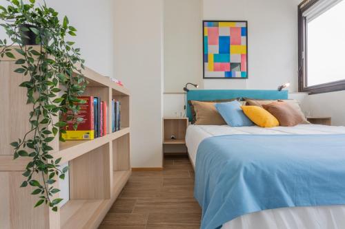 a bedroom with a bed and a book shelf at Garden Palace by Wonderful Italy - Apartment in Turin