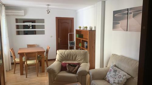 a living room with a chair and a table at Nice Home+Wifi+AC+Netflix in Valladolid