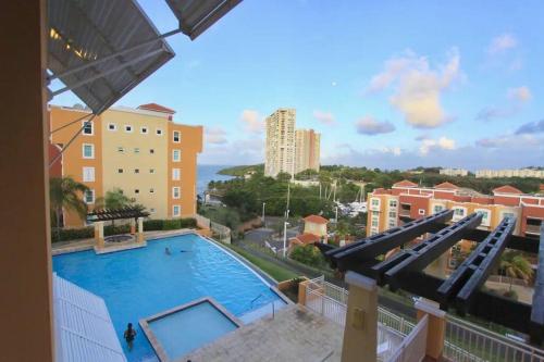 a view of a swimming pool from a building at 506 Ocean & Marina Views 3 Bedroom 2 Bathroom Lux in Fajardo