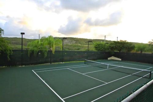 a tennis court with a net on top of it at 506 Ocean & Marina Views 3 Bedroom 2 Bathroom Lux in Fajardo