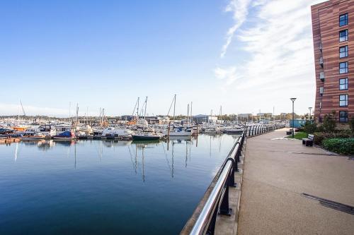 a marina with boats in the water next to a building at Deanery Court Vittrum Suites in Southampton