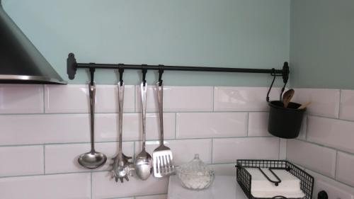 a group of utensils hanging on a kitchen wall at Casa Moreno in El Cuervo