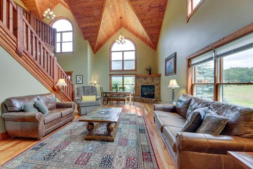 a living room with a couch and a table at Slaty Fork Home about 6 Mi to Snowshoe Mountain Resort in Slaty Fork