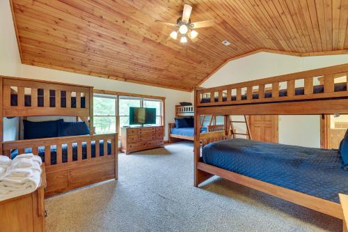 a bedroom with two bunk beds and a tv at Slaty Fork Home about 6 Mi to Snowshoe Mountain Resort in Slaty Fork