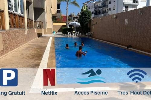 - un groupe de personnes se baignant dans une piscine dans l'établissement Eden Appartement avec Piscine Et Salle de Sport, à El Jadida