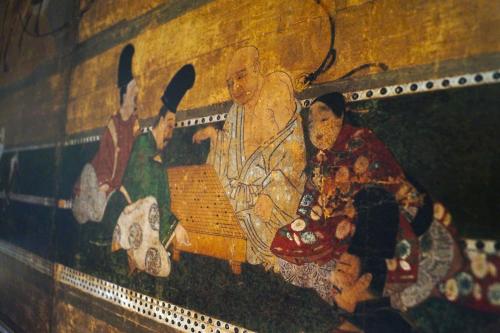 a wall with a painting of people on it at Manoir de Laroque Delprat in Autoire