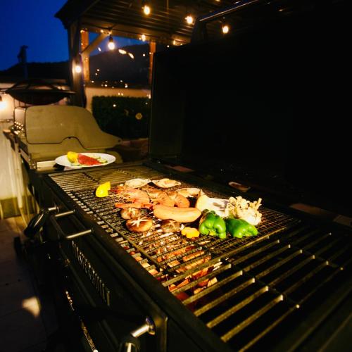 a grill with meat and vegetables on it at Vacanza Resort in Gifu