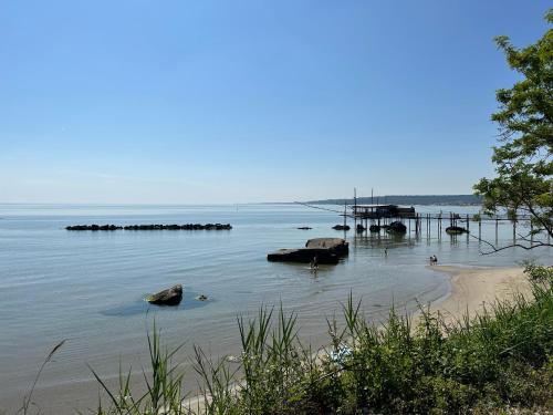 a body of water with a beach and a dock at Da Concy in Fossacesia