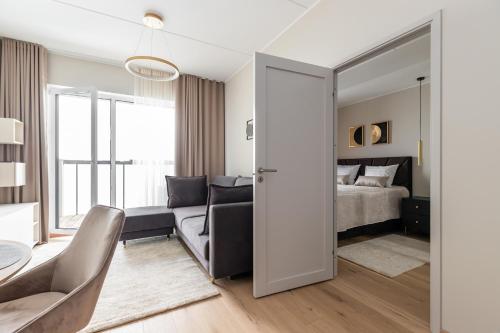 a bedroom with a bed and a living room at Laulupargi Lux Residence in Tallinn
