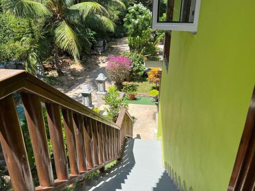 a stairway leading down to a house with a garden at Chloe's Cottage Self-Catering in La Digue