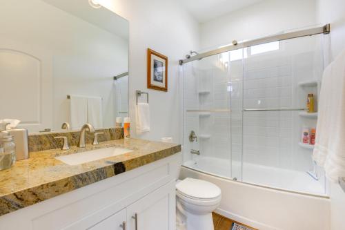 a bathroom with a shower and a toilet and a sink at Serene Pahrump Cottage with Mountain Views! in Pahrump
