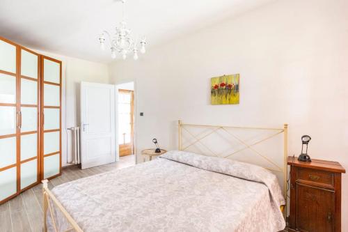 a bedroom with a bed and a chandelier at Il Truciolo in Castellaccia