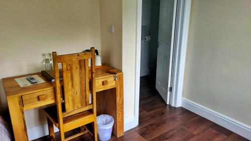 リンドハーストにあるThe Trusty Servant Innの木製テーブルと木製椅子が備わる客室です。