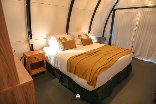 a bedroom with a large bed in a tent at GLAMPING SELVA IGUAZU in Puerto Iguazú