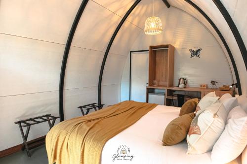 a bed in a room with an arched ceiling at GLAMPING SELVA IGUAZU in Puerto Iguazú