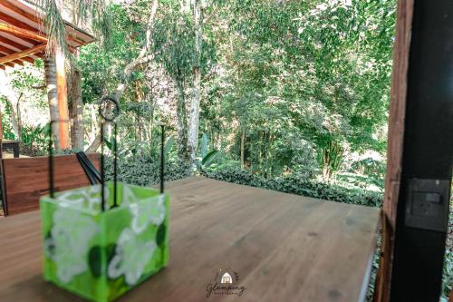 a vase sitting on a table in front of a window at GLAMPING SELVA IGUAZU in Puerto Iguazú