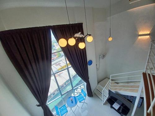 a room with a large window with curtains at SY Staycation - Studio in Bayan Lepas