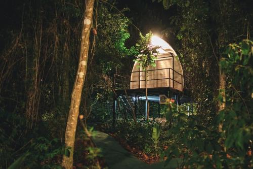 a tree house in the woods at night at GLAMPING SELVA IGUAZU in Puerto Iguazú