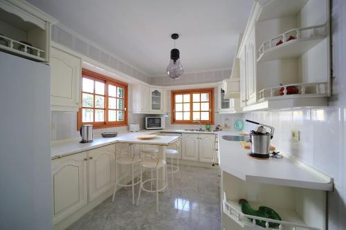 a kitchen with white cabinets and a counter top at Villa Teram in Alajeró