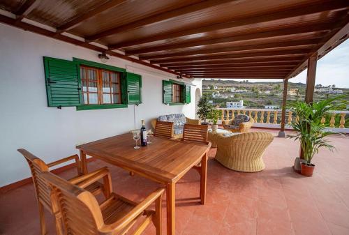 a wooden table and chairs on a patio at Villa Teram in Alajeró