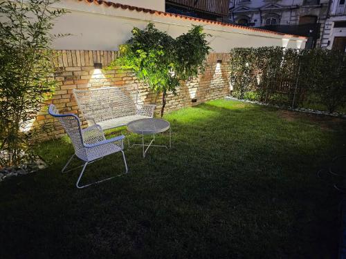 two chairs and a table in a yard at Rosetti One in Constanţa