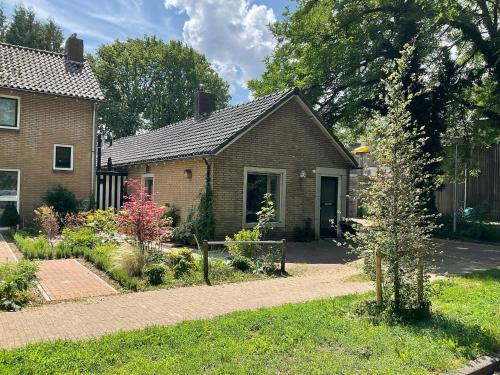 a house with a garden in front of it at B&B Het Postkantoortje in Gorssel