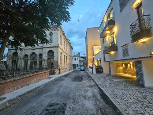 an empty street in a city with buildings at Rosetti One in Constanţa