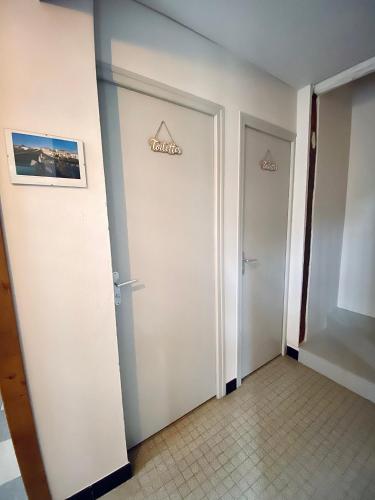 a corridor of a hotel room with two doors at Domaine de la Source in Sainte-Christie-dʼArmagnac