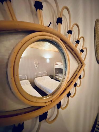 a mirror reflecting a bed in a room at Domaine de la Source in Sainte-Christie-dʼArmagnac