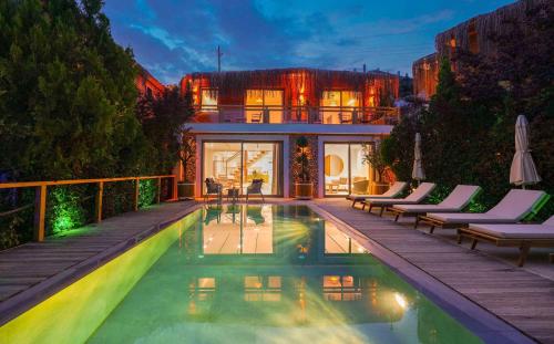a house with a swimming pool in front of a house at Likya Gardens Hotel in Kas