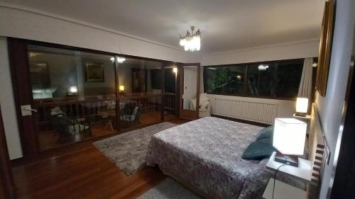 a bedroom with a bed and a view of a dining room at Azkorri Beach House in Getxo