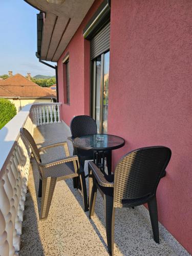 a patio with chairs and a table on a building at Apartman Aleks in Banja Koviljača