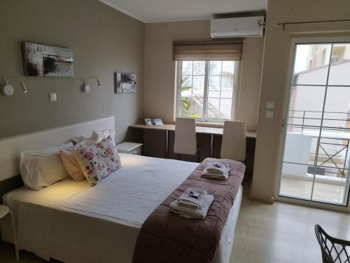 a bedroom with a bed with two towels on it at Villa Katerina in Chania Town