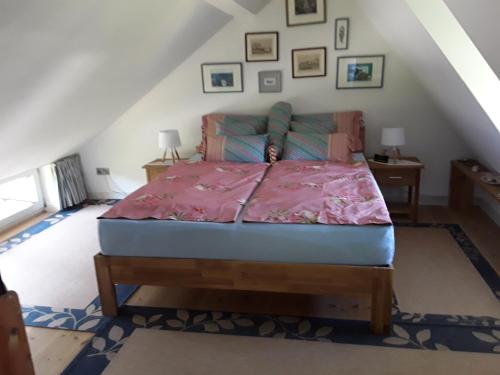 a bedroom with a bed in a attic at Das Rosenhaus in Utersum