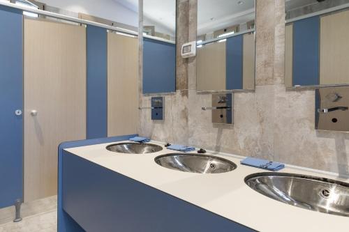 two sinks in a public bathroom with blue at PuntAla Camp & Resort in Punta Ala