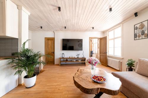 a living room with a couch and a coffee table at Boutique apartment Mezrozite in Kuldīga