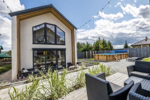 a home with a patio with chairs and a pool at SpaceroVa in Nadole