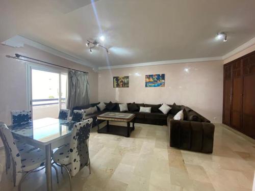 a living room with a couch and a table at Marina Agadir Comfy Apartment in Agadir