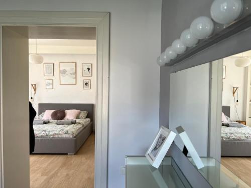 a room with a mirror and a bedroom with a bed at Apartamenty Rajcza in Rajcza