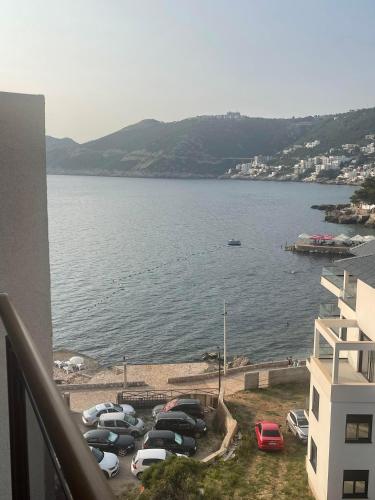 a group of cars parked next to a large body of water at Apart Hotel XXL Lux in Dobra Voda