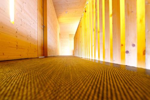 an empty room with wooden walls and a wooden floor at Refugio Laudegg in Ladis