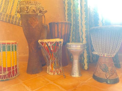 a group of different colored vases sitting on a floor at Riad Dar Barbara in Ouarzazate