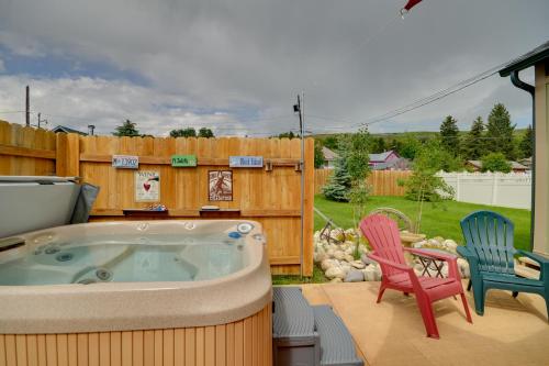 a hot tub sitting on a patio with two chairs at Red Lodge Retreat with Hot Tub 3 Blocks to Downtown in Red Lodge